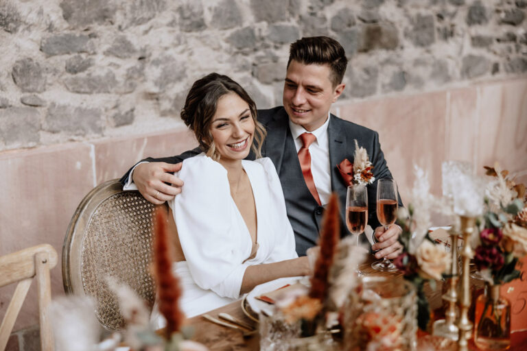 Romantik trifft Eleganz- Hochzeitsinspiration - Styled Shooting - Brautpaar am festlich gedeckten Tisch
